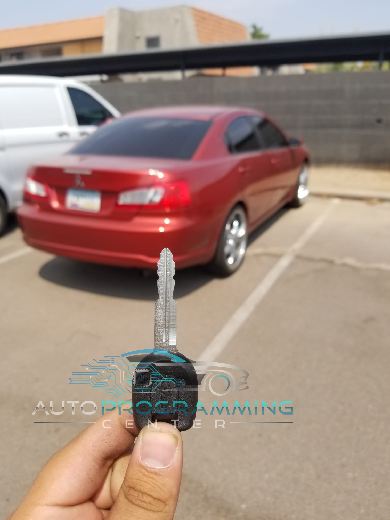 High-resolution image showcasing an automotive locksmith programming a Mitsubishi key fob for enhanced security and convenience.